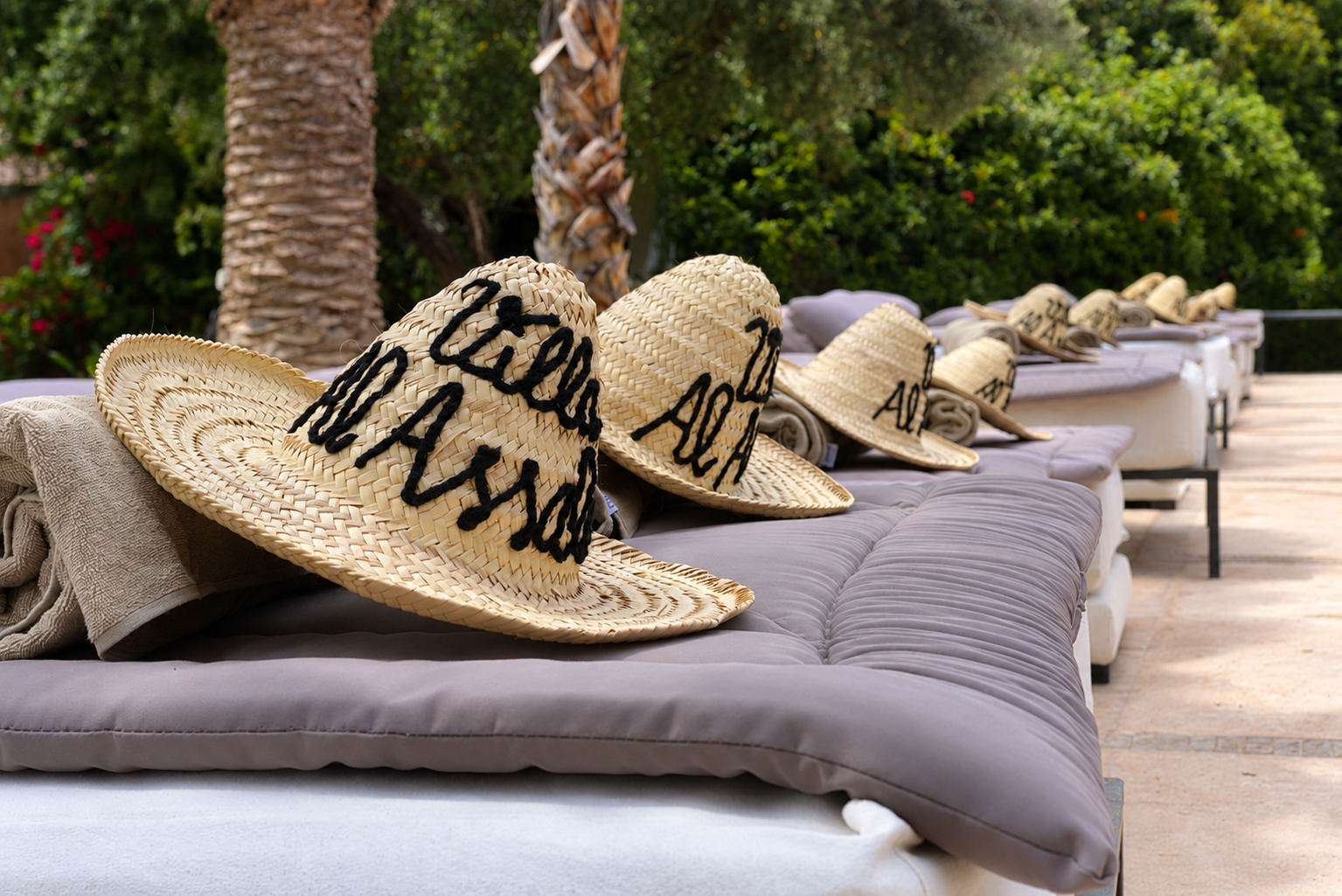 Transats au bord de la piscine, chapeaux Villa Al Assala
